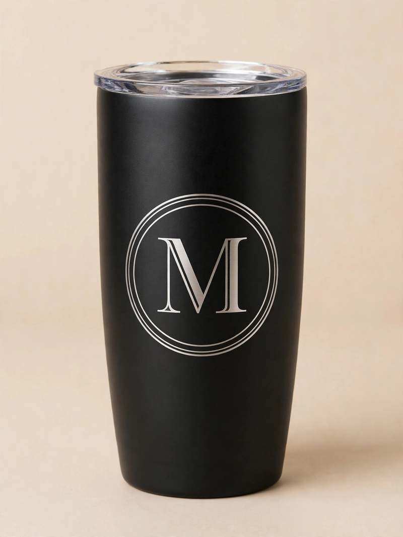 Black tumbler laser-etched with monogram ring and letter M