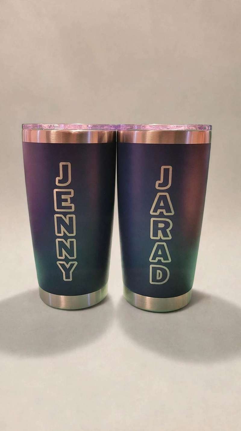 Two navy tumblers etched with the names Jenny and Jarad