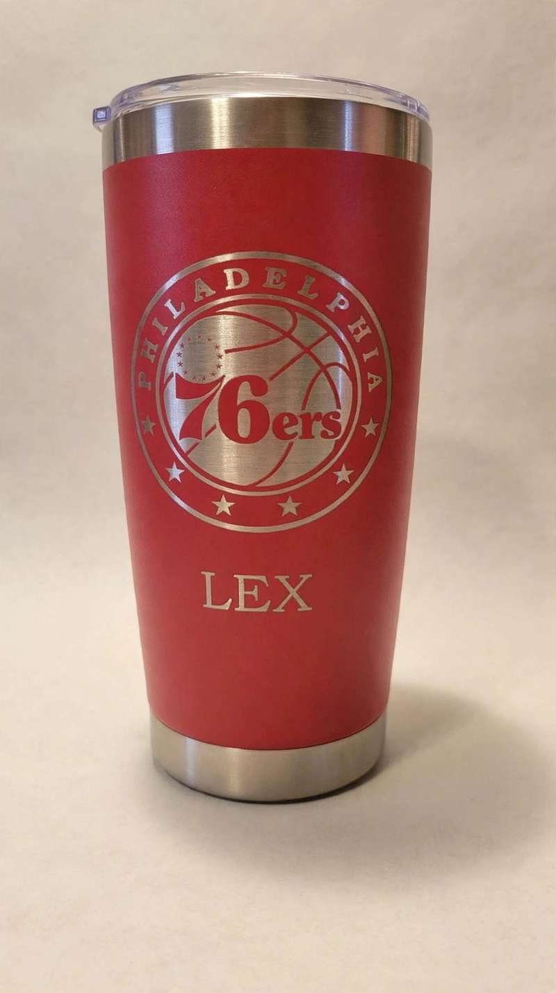 Red tumbler laser-etched with Philadelphia 76ers logo and the name Lex